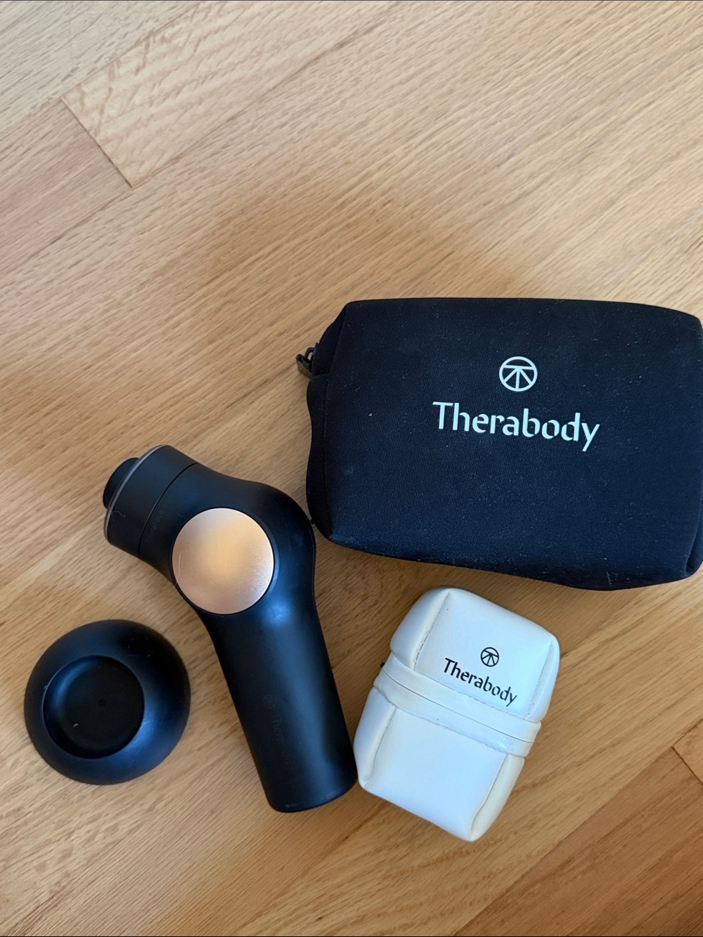 Therabody Percussion Massage Gun with Black Carry Pouch and White Accessory Case